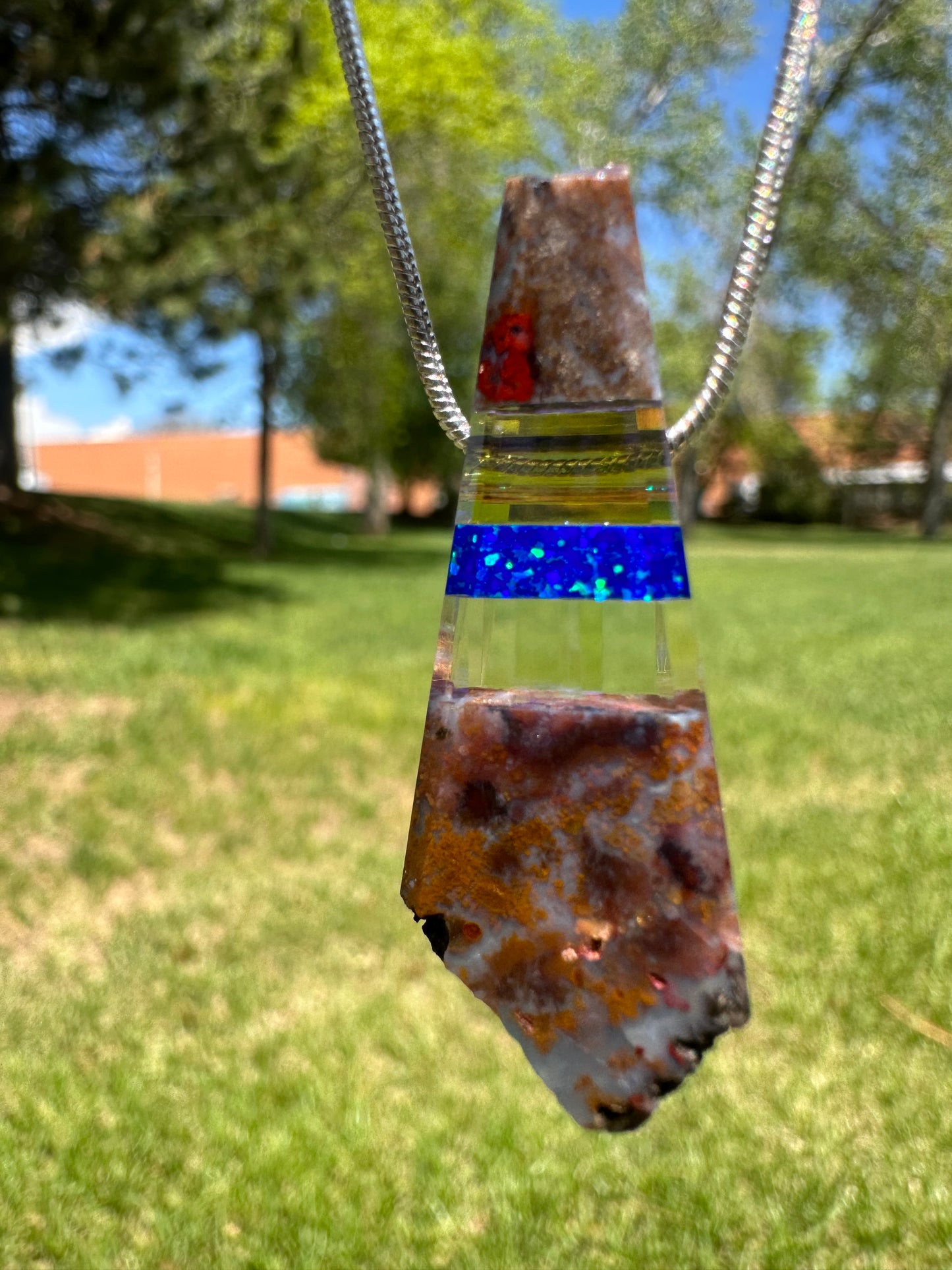 “Raw” rock pendant with blue opal and dichroic glass